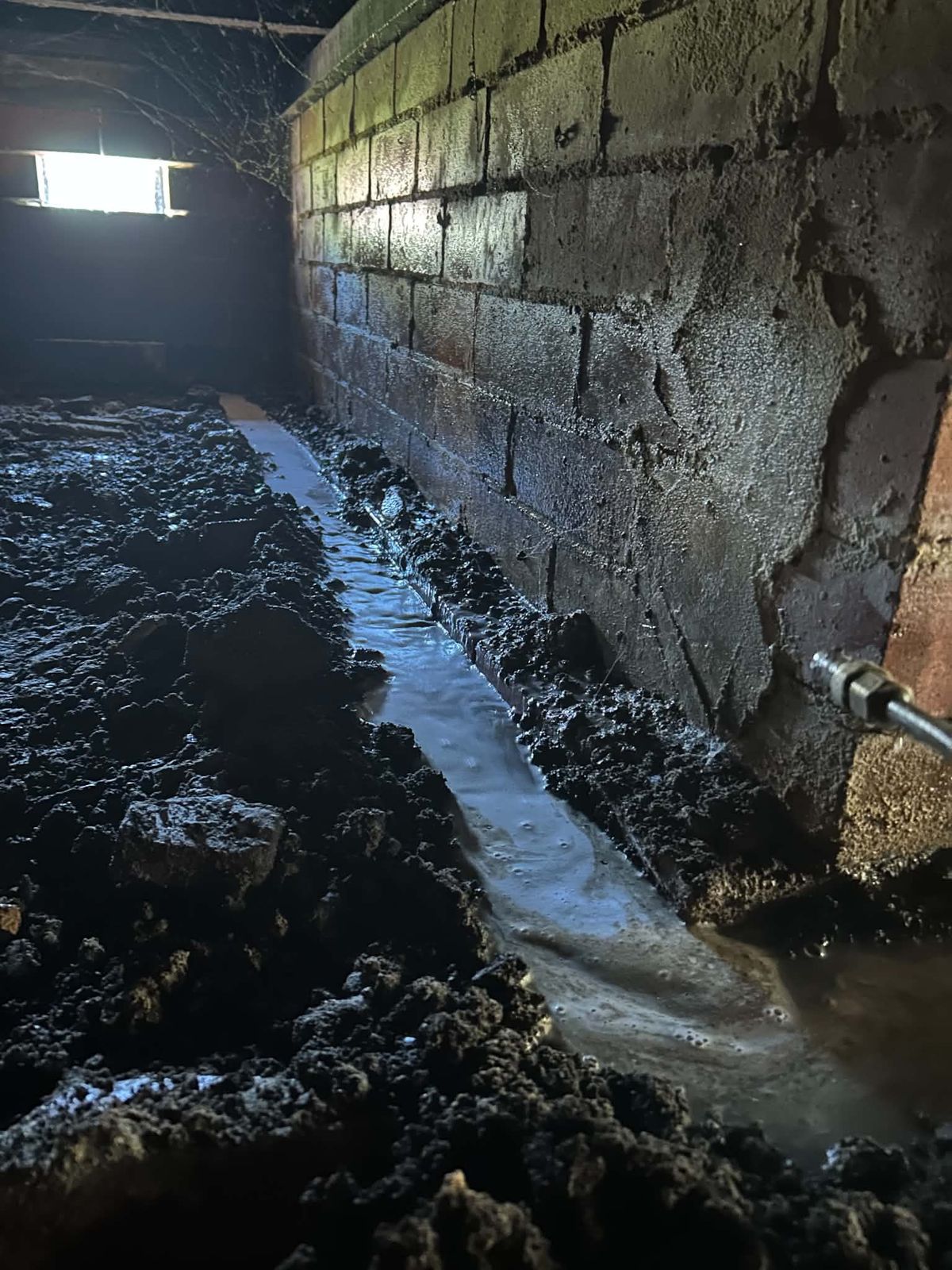 Subfloor termite treatment along the foundations